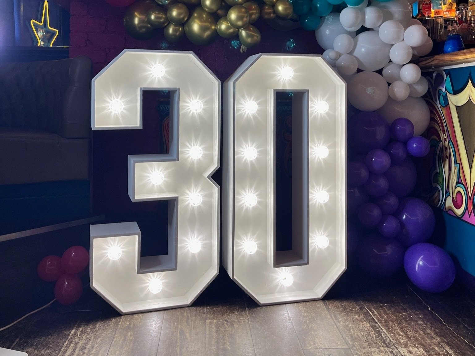 Illuminated number 30 light up letters with balloon garland at a Leeds birthday party