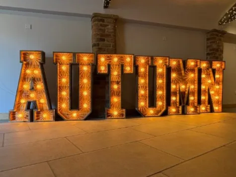 Rustic light up letters spelling AUTUMN in a Yorkshire barn