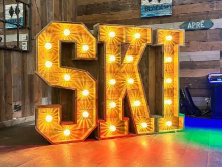 Rustic light up letters spelling SKI at an event