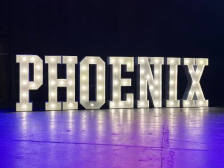 White light up letters spelling PHOENIX