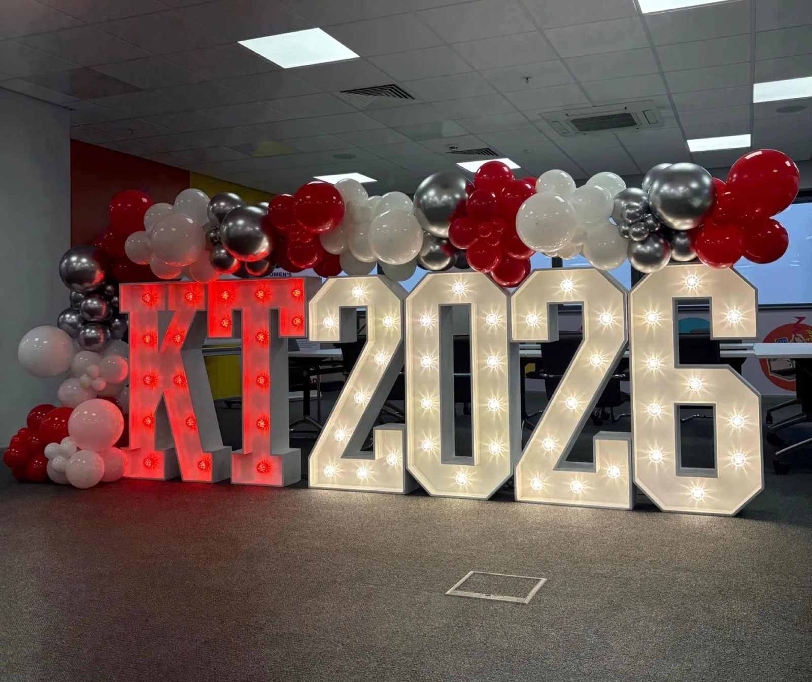 White light up KT 2026 with red balloons