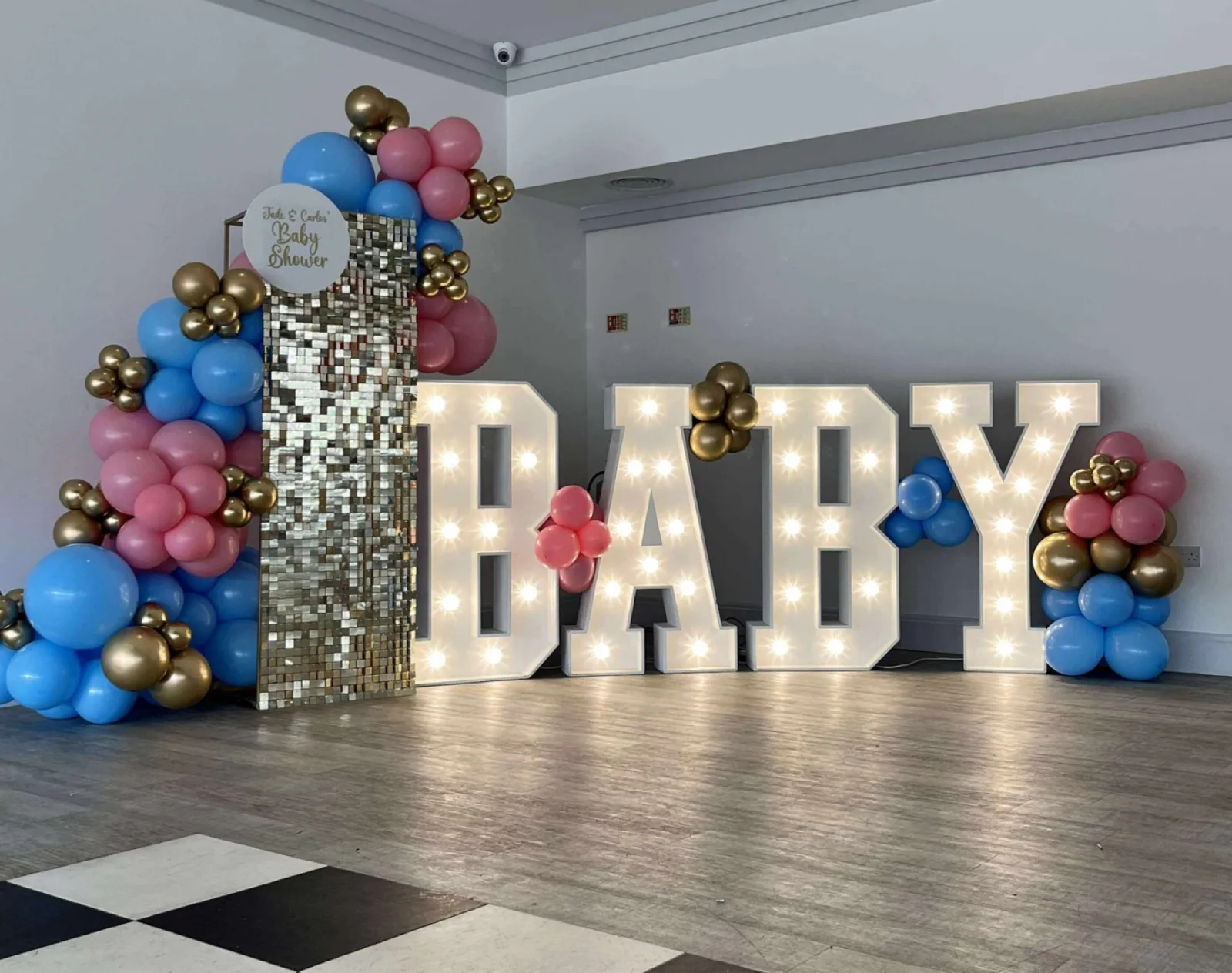 White light up letters spelling BABY with balloons
