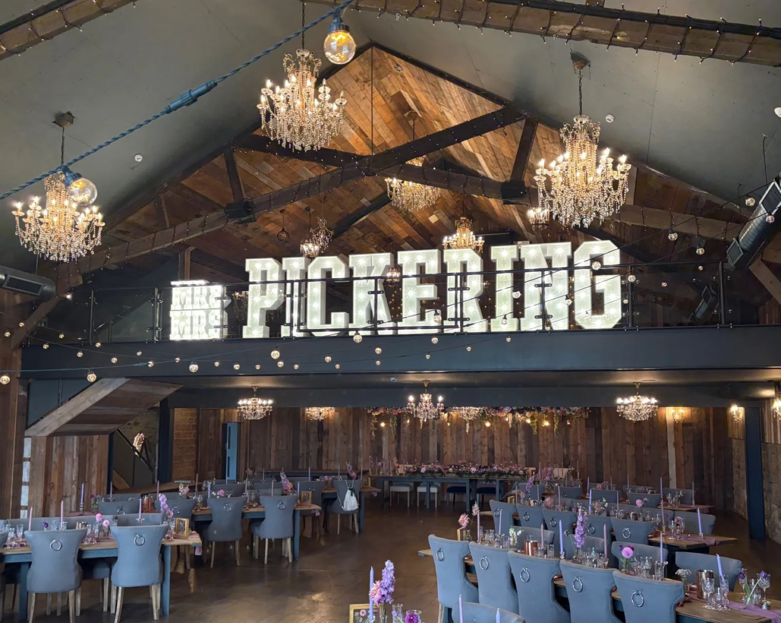 White light up letters spelling PICKERING in a ballroom